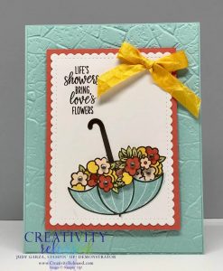 An encouragement card using the Under My Umbrella stamp set. The umbrella is up-side-down and filled with flowers