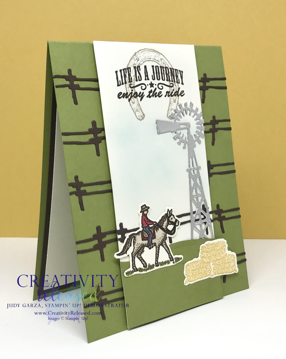 A side view of a Texas-style card with fencing across an Old Olive card base. The white center panel displays a cowboy on a horse, bales of hay and a windmill, all from the Stampin' Up! stamp set "Ride The Range"