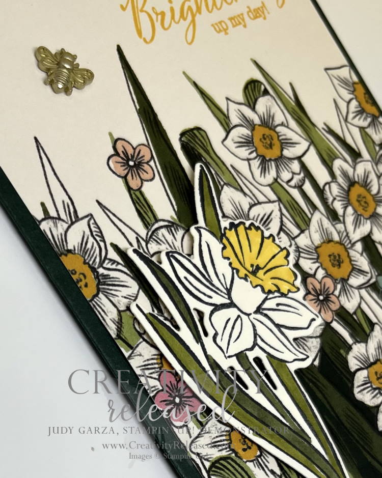 An up-close view of a greeting card with yellow and white Daffodils the sentiment "Thanks for Brightening up my day." It has a bumblebee trinket buzzing over the flowers. All products are by Stampin' Up!