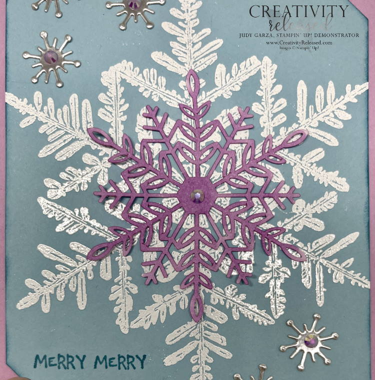 An up-close look at a Merry, Merry Christmas card in Fresh Fresia, Balmy Blue and Silver, showcasing the Snow Chrystal background stamp by Stampin' Up!