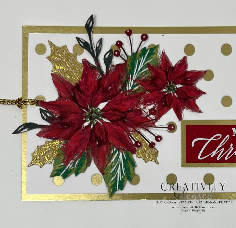 An up-close look at a Poinsettia Christmas gift tag made with gold foil as the base, Basic white atop after die-cut with Dots & Spots. Finally, a poinsettia cut from the Boughs of Holly designer paper adhered to the left side with gold leves tucked behind it. The sentiment is white heat-embossed on real red then layered onto gold foil.