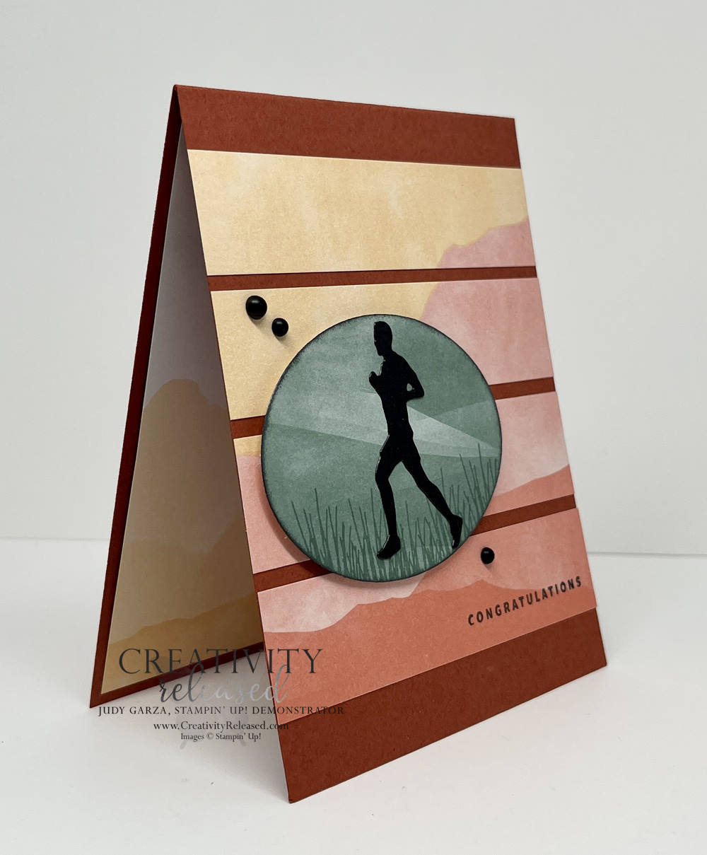A side view of an outdoorsy card of congratulations. A mountainous background with the silhouette of a runner in a focal oval. All products by Stampin' Up!