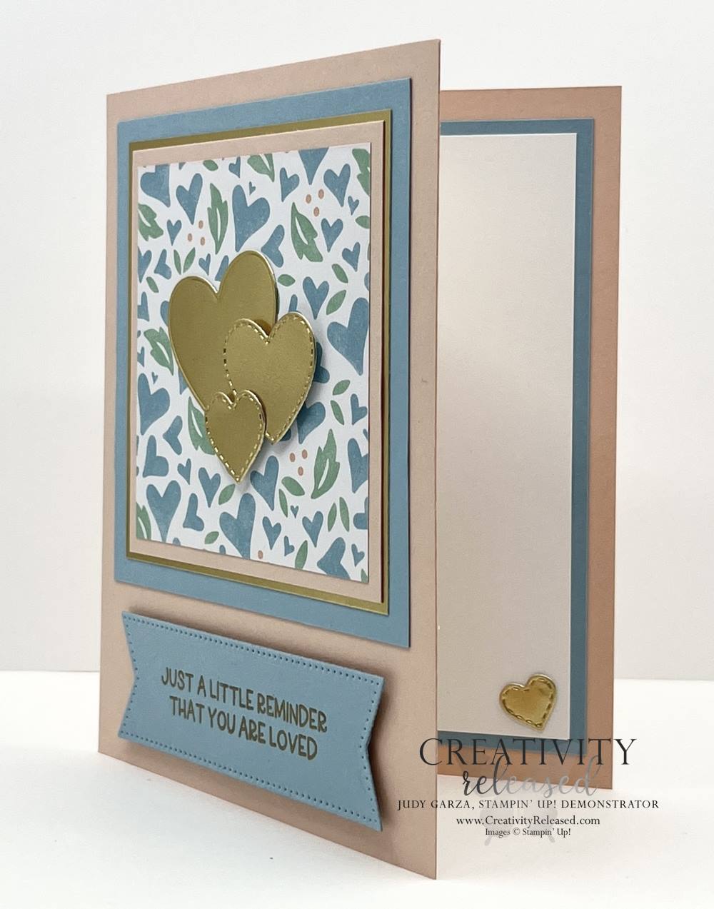 A side view of a Pink, Balmy Blue and gold greeting card to remind someone that they are loved.