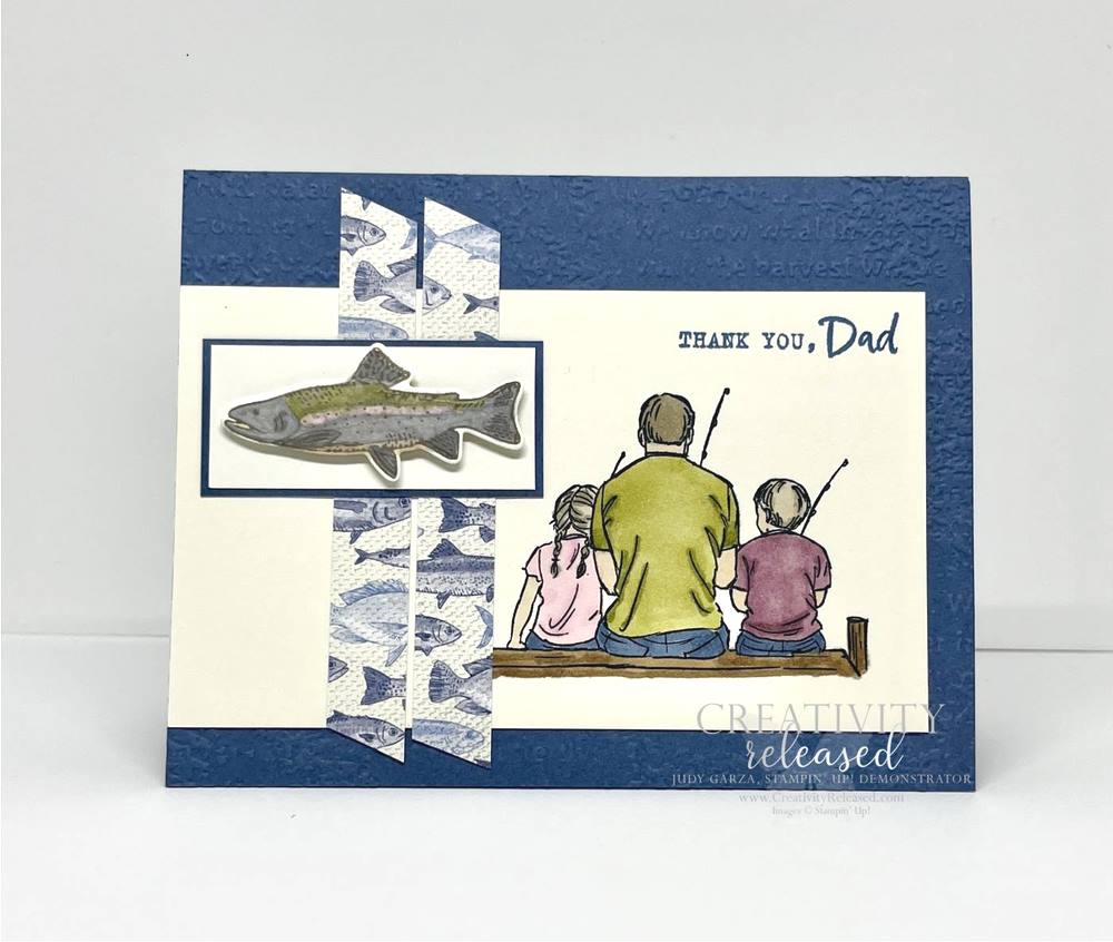 A Father's Day card with a man and two kids sitting on a pier, fishing. Also displays a rainbow trout.