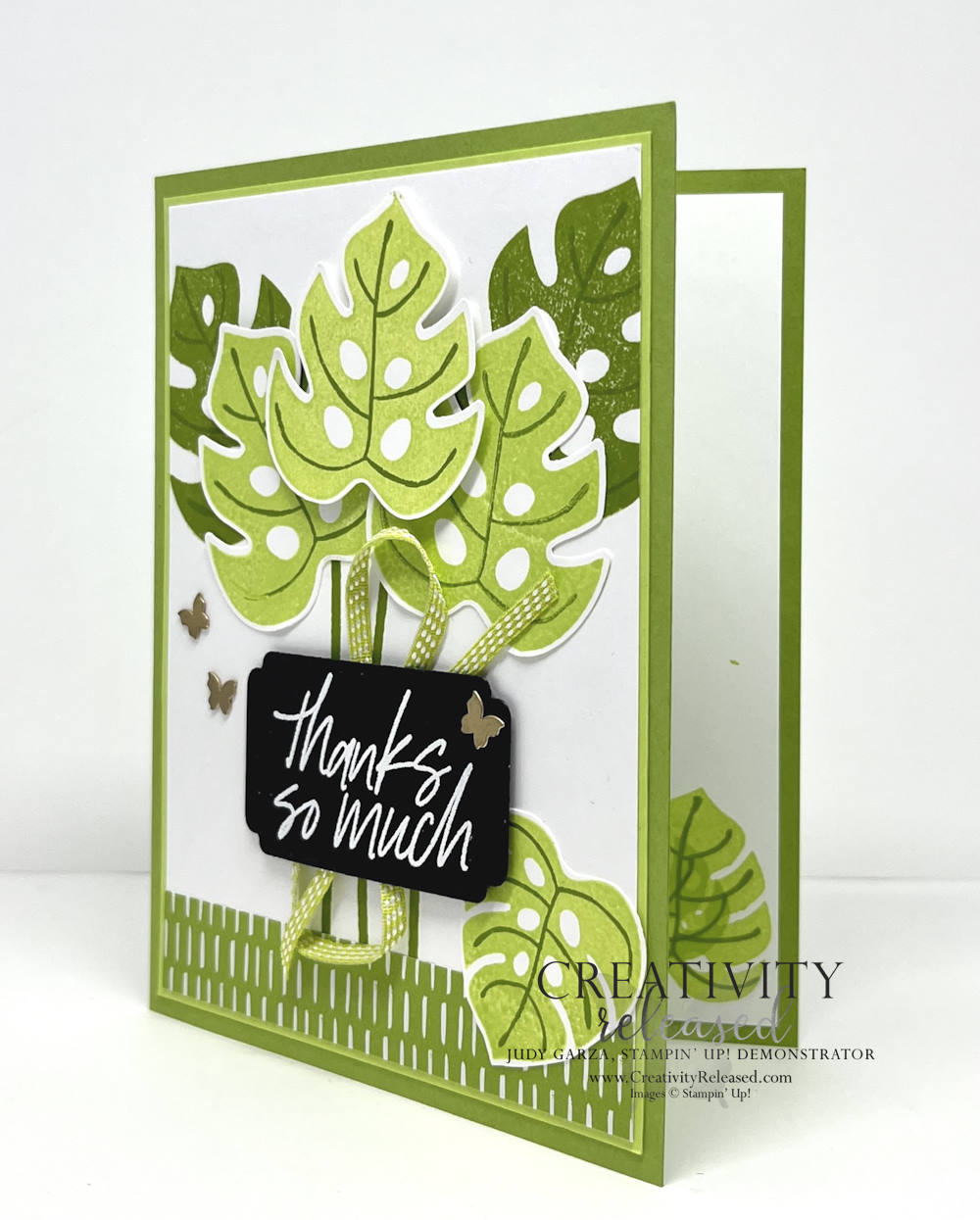 Side view of a thank you card with tropical leaves in two green tones and a white heat embossed sentiment on black. All products by Stampin' Up!